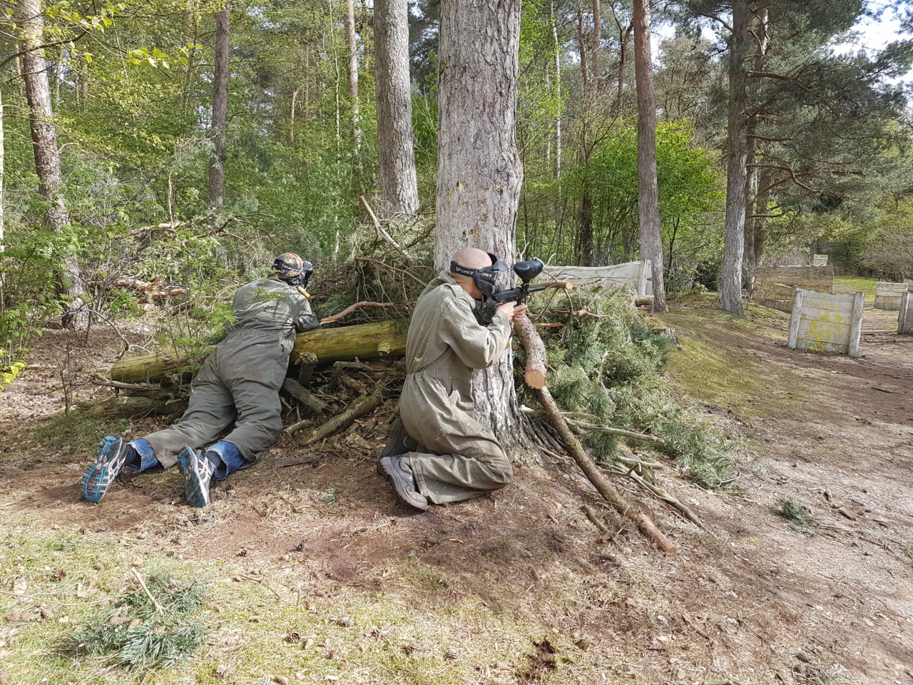 Paintballspieler suchen Deckung hinter einem Baum